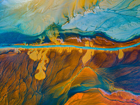 A river running through a red and blue field