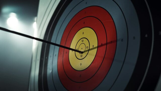 Slow Motion of an Arrow Hitting a Target. Close Up on an Arrow Hitting the Bullseye on a Colorful Board. Talented Athlete Training for a Championship Match. Aesthetic Zoom In Footage