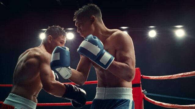 Cinematic Boxing Match in Super Slow Motion. Boxer Avoiding a Punch and Countering with a Hook to the Body, Surprising the Opponent. Aesthetic Footage with a Speed Ramp Action Effect