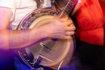 Banjo player playing music instrument during concert - obrazy, fototapety, plakaty