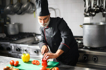 Chef cutting a red pepper