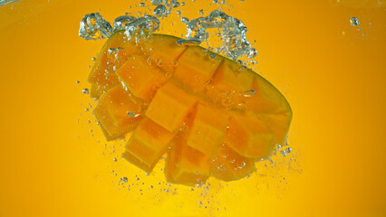 Freeze motion of falling fresh mango fruit into water