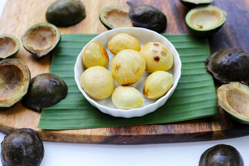 Djenkol fruit bean on wooden cutting board