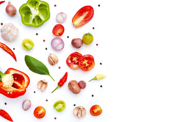 Various fresh vegetables and herbs on white background.