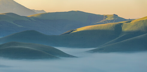 Fog and haze over castelluccio's hills