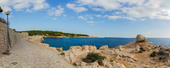 Coastal walkway at Cala Ratjada, Mallorca island, spain, with rocky coast (panorama)