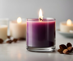 Obraz na płótnie Canvas Purple burning candle standing on a white table