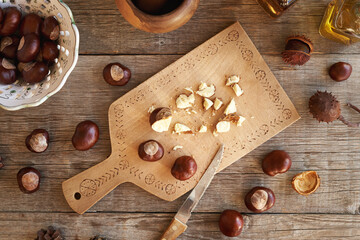 Cutting up fresh horse chestnuts to prepare herbal tincture