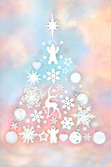 Christmas tree surreal festive design with white bauble decorations on rainbow sky background....