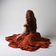 Full length portrait of beautiful red haired woman wearing a medieval maiden, fortune teller...