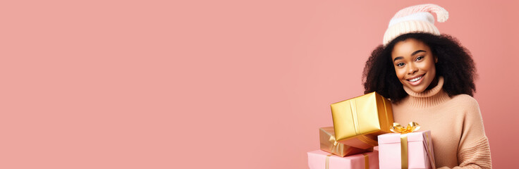 Pretty african american woman holding gift box in arms on pink background. Happy smiling girl with christmas present in her hands - Powered by Adobe