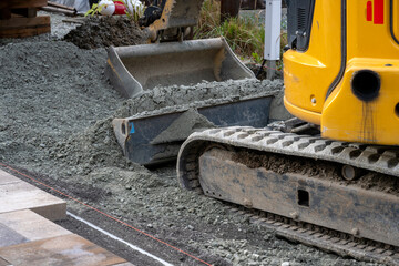 Fototapeta na wymiar An excavator on a gravel surface