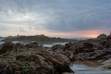 Rocky sea beach at sunset