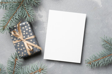 Fototapeta na wymiar Christmas mockup, greeting card with gift box and fir tree branches