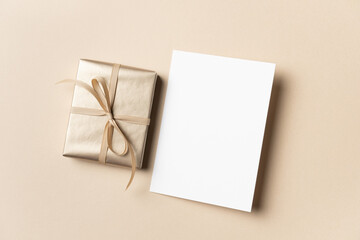 Greeting card mockup with golden gift box, blank card mock up with copy space for text or design