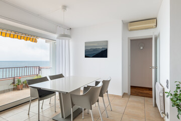 Empty table and chairs near panoramic terrace window