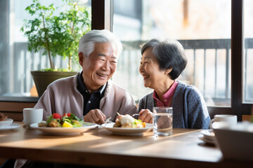 .Joyful Asian elderly man and woman or family spending time together having lunch in restaurant - Powered by Adobe