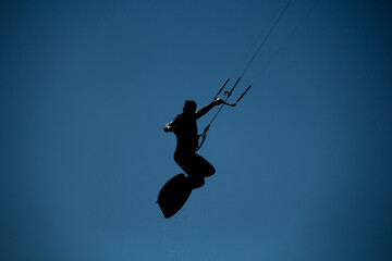 Kite surfer performing a big air jump