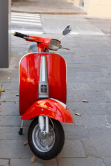 shiny red scooter on Italian street © Tamela
