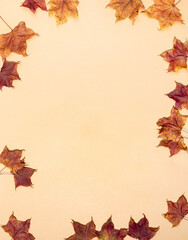 Frame of color fall maple leaves on neutral light beige background. Top view. Flat lay. Copy space.