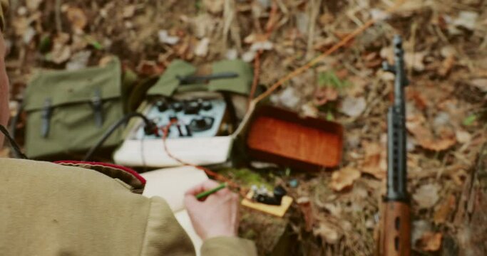 Men Dressed Like Russian Soviet Infantry Red Army Soldiers In World War II using Russian Soviet Portable Radio Transceiver In Trench Entrenchment Ambush In Spring Autumn Forest. 4K. Headphones And