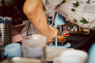 Barista making an extraction of freshly brewed espresso coffee from a Leverpresso.