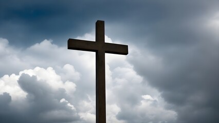 Cross on blue sky. Isolated cross on cloudy sky. Catholic cross symbol.