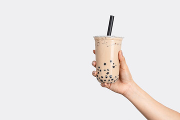 Fototapeta premium Hand holding bubble milk tea isolated on white background.