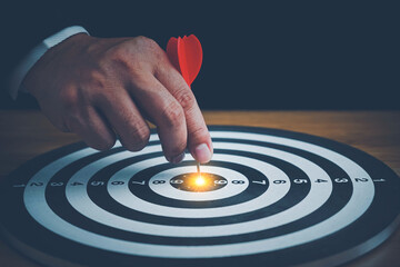 Fototapeta na wymiar Targeting the business concept, Businessman throwing red arrow dart to virtual target dart board.Setup objectives and target for business investment concept,Digital marketing,Business target concept