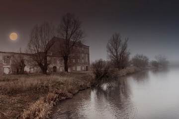 Gloomy Halloween landscape with an abandoned house and the moon.