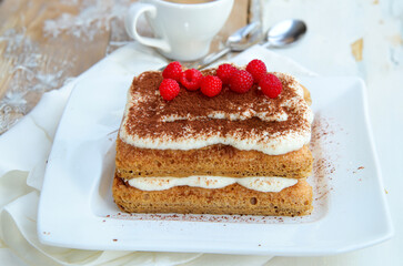 tiramisu cake with fresh berries on a plate for dessert