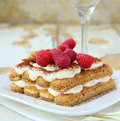 tiramisu cake with fresh berries on a plate for dessert