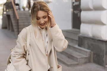 Fashion woman wearing beige coat on the street - 666595734