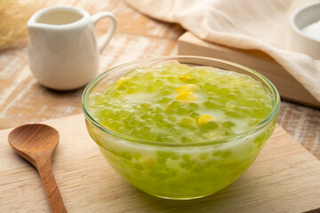 Pandan flavoured Tapioca pearl pudding (Sago) with a dash of coconut milk,popular South-East Asian dessert in glass bowl