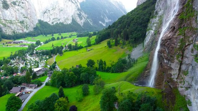 Aerial view of Lauterbrunnen cityscape waterfall and grass from drone view in switzerland