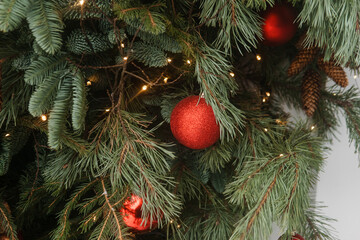 Christmas trees decorated with red balloons in front of the cafe entrance. Street Christmas decorations.