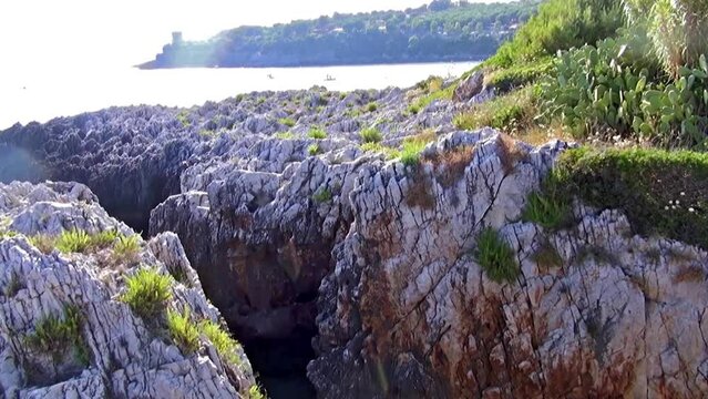 Fascinating long and narrow inlet within a steep jagged cliff with Mediterranean scrub above.