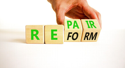 Reform and repair symbol. Concept words Reform Repair on wooden block. Beautiful white table white...