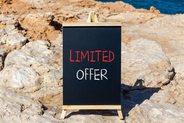 Limited offer symbol. Concept words Limited offer on beautiful black chalk blackboard. Beautiful stone sea blue background. Business marketing, motivational Limited offer concept. Copy space.