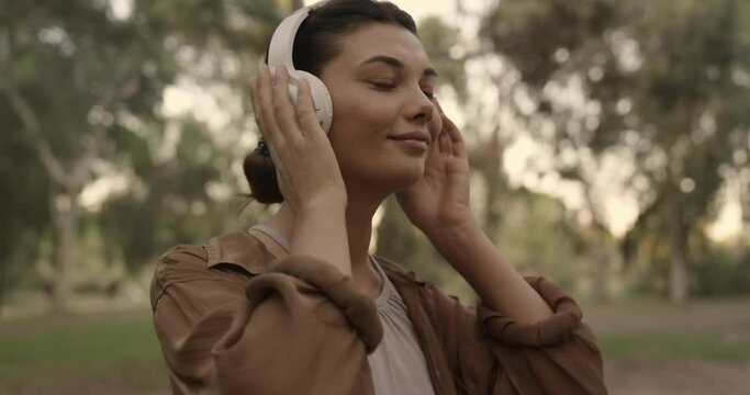 Woman listening to music with headphones in the nature