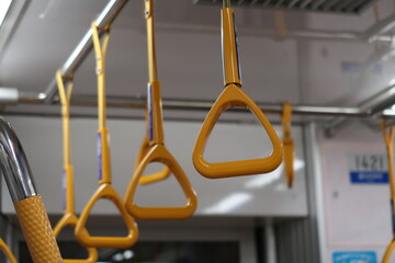yellow hand strap inside an empty  subway or train