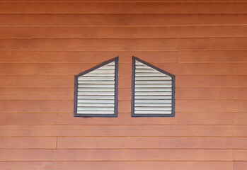 two windows at wood wall