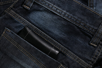 Closeup to man, jeans with wallet in pocket.