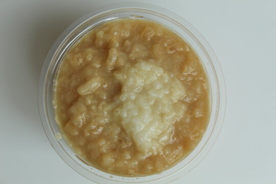 Bubur merah putih, traditional sweet porridge from Java, Indonesia. In a plastic cup. Isolated on white background. Flat lay or top view