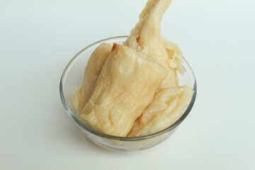 Tapai is fermentation of cassava with yeast. Indonesian snack. Isolated on white background