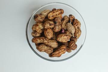 Boiled peanuts or steamed peanut, on a transparent bowl, isolated on white background. Flat lay or top view