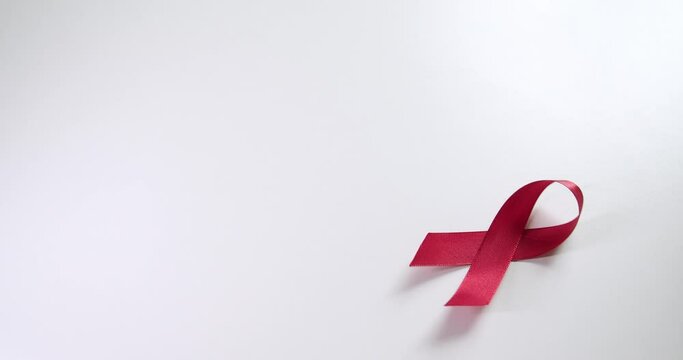 Placing a red ribbon on the right side of the frame which signifies the HIV-AIDS worldwide disease awareness and prevention.