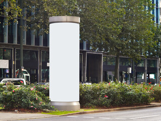 Empty advertising pillar in a city with white free copy space, promotion mock up. Blank advertising...
