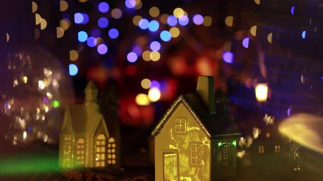 Christmas decorations close-up.  Small houses with a garland on the background of bokeh.