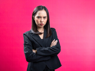 Portrait of an Asian Indonesian woman wearing a black work shirt, posing in an annoyed manner with...